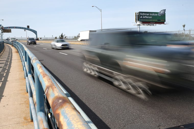 Vehicles pass a billboard on the Ben Franklin Bridge touting the Rothman Institute at Jefferson as a partner with the Eagles.