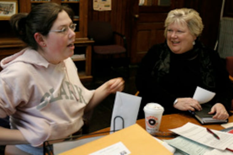 University Park principal June Eressy listens to Kimberly Surrette, a Clark University student on an internship atthe high school. She is the oldest of 10 children who are University Park graduates, students or students-to-be.