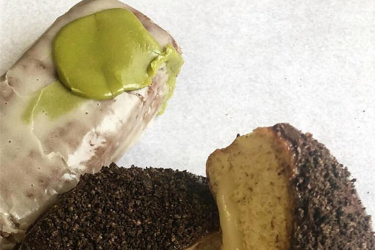 The Eagles Fan on a Greased Pole (left) with the cookies-and-cream doughnut at Dottie’s Donuts.