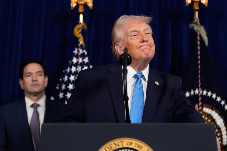 President Donald Trump listens to a question during a news conference at Mar-a-Lago, Saturday, Jan. 3, 2026, in Palm Beach, Fla., as Secretary of State Marco Rubio watches.