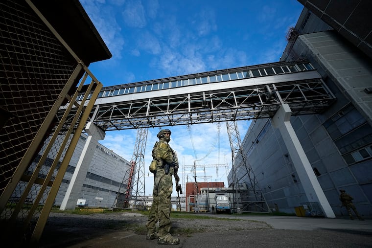 This May 1 photo shows a Russian serviceman guarding an area of the Zaporizhzhia Nuclear Power Station in territory under Russian military control, southeastern Ukraine.