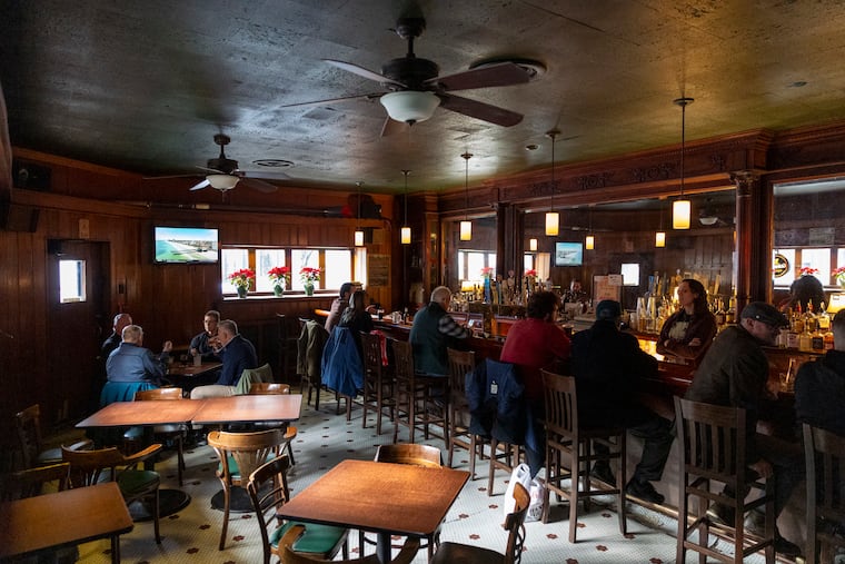 People seated inside Cherry Street Tavern enjoying drinks and food in Philadelphia on Friday, Dec. 19, 2025.