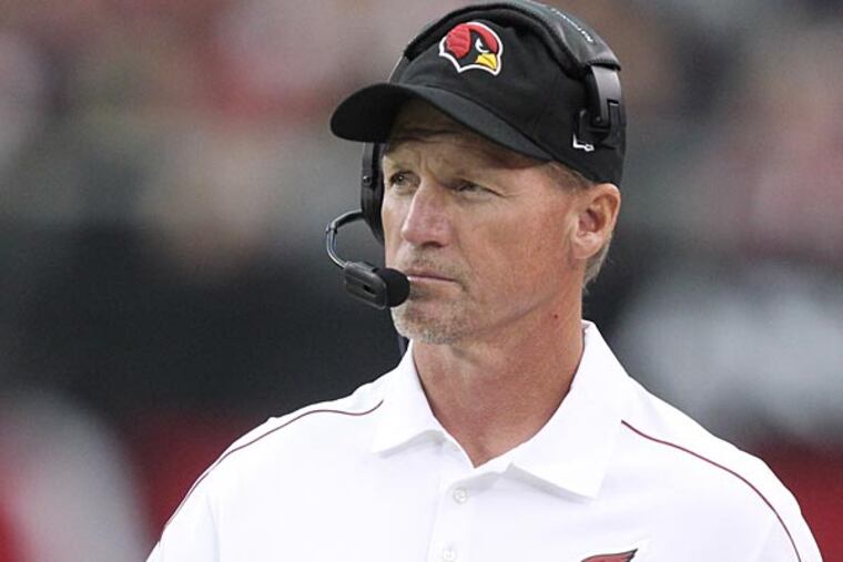 Arizona Cardinals head coach Ken Whisenhunt makes a call against the St. Louis Rams during the first half of an NFL football game, Sunday, Nov. 25, 2012, in Glendale, Ariz. (AP Photo/Paul Connors)