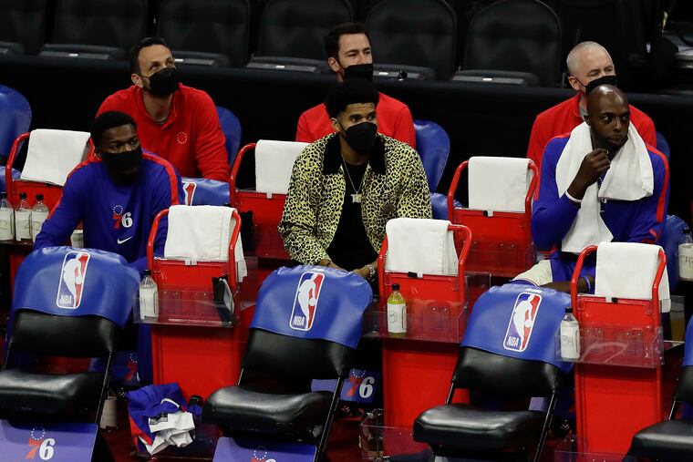 Sixers forward Tobias Harris (center) sits on the bench in street clothes against the Clippers on April 16.