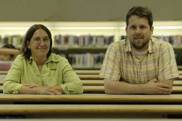 Singing the praises of a collection agency that uses seminary students are director Martina Kominiarek and Det Ansinn at the Bucks County Free Library. (Jonathan Wilson/Inquirer)