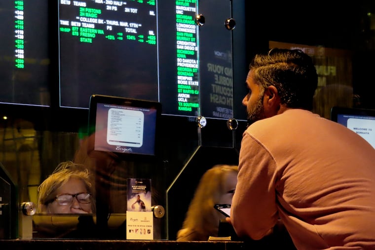 A customer makes a sports bet at the Borgata casino in Atlantic City N.J. on March 17, just before the March Madness college basketball tournament began.