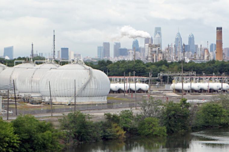 Large storage tanks sit on the southern bank of the Schuylkill at the Sunoco refinery in South Philadelphia, which is up for sale. (Michael Bryant / Staff Photographer)
