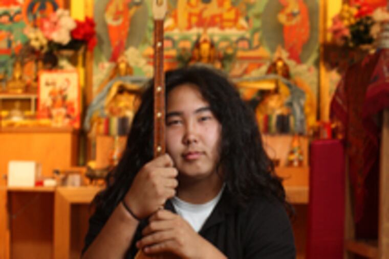 Alex Kalatschinow, 15, is in a rock band but also plays the "dombra," a traditional Kalmyk instrument.