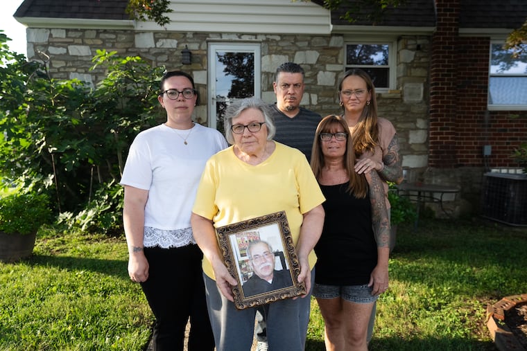 The family of Vito Maglio gathers outside their family home after learning that police made an arrest in his 2014 killing this week. From left to right: Lucia Thrasher, Maria Maglio, Vito Maglio Jr., Terry Maglio, and Sandra Maglio said they were grateful that police took another look at the case this summer.