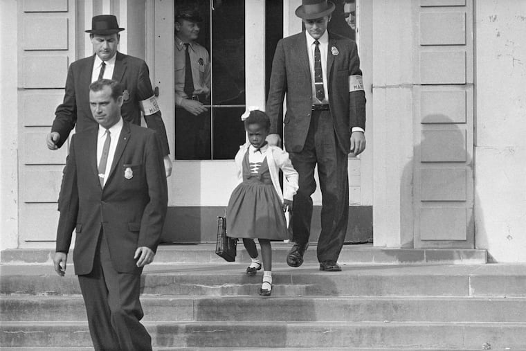 U.S. Deputy Marshals escort 6-year-old Ruby Bridges from William Frantz Elementary School in New Orleans on November 14, 1960. A coin with her image suggested for the 250th anniversary of the U.S. was rejected by the Trump administration.