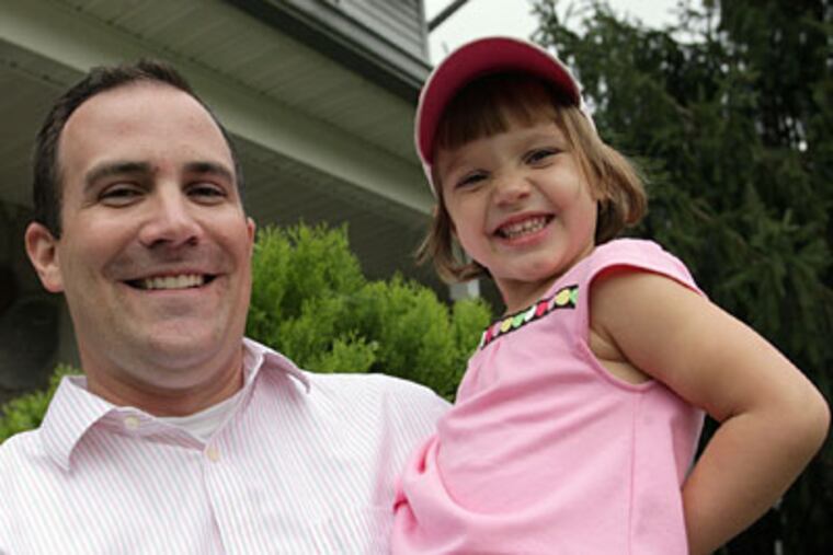 Emily Monforto, 3, and her father Stephen Monforto at their south Jersey
NJ home. Stephen Monforto caught a foul ball at the Phillies game, only to have Emily toss it back. (Yong Kim / Staff Photographer)