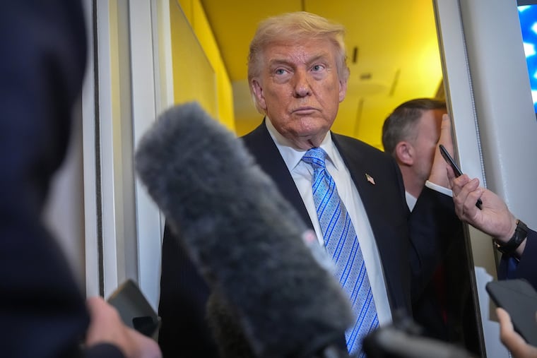 President Donald Trump speaks to reporters aboard Air Force One, Friday, May 15, 2026, as he returns from a trip to Beijing, China.