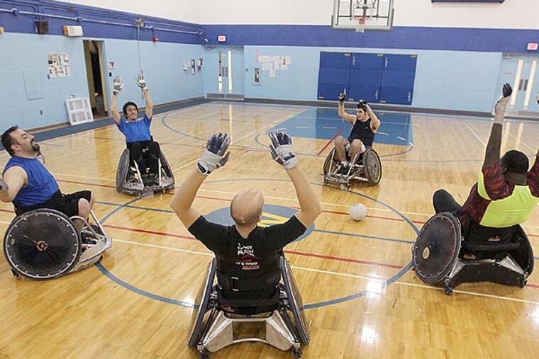 Members of the Akron Rhinos quad rugby team stretch before practice at Weaver Learning Center in Tallmadge, Ohio, on January 17, 2014. (Phil Masturzo/Akron Beacon Journal/MCT)