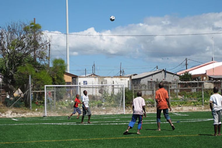 Local residents play soccer at the Chris Campbell Memorial Field in Khayelitsha, South Africa.