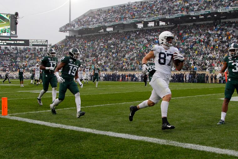 Penn State's Pat Freiermuth running in for a touchdown on a pass reception against Michigan State's Josh Butler (19), Tre Mosley (17) and Xavier Henderson on Oct. 26, 2019.
