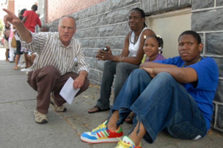 Volunteer Skip Wiener discusses the garden project withAverie Cherry and her children, Jere and David.