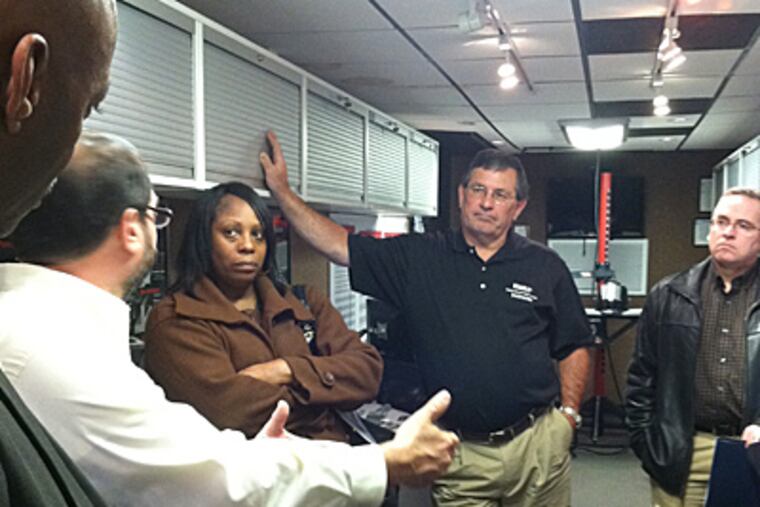 Mobile Outreach Skills Training (M.O.S.T.) has its training lab, shown in the company photo right, with basic machining, in a tractor-trailer. Inside the mobile classroom, Dawn Thompson, of Fiber-Line Inc., above, listens as Ted Astolfi explains the recruiting and training program. (Jane Von Bergen / Staff)