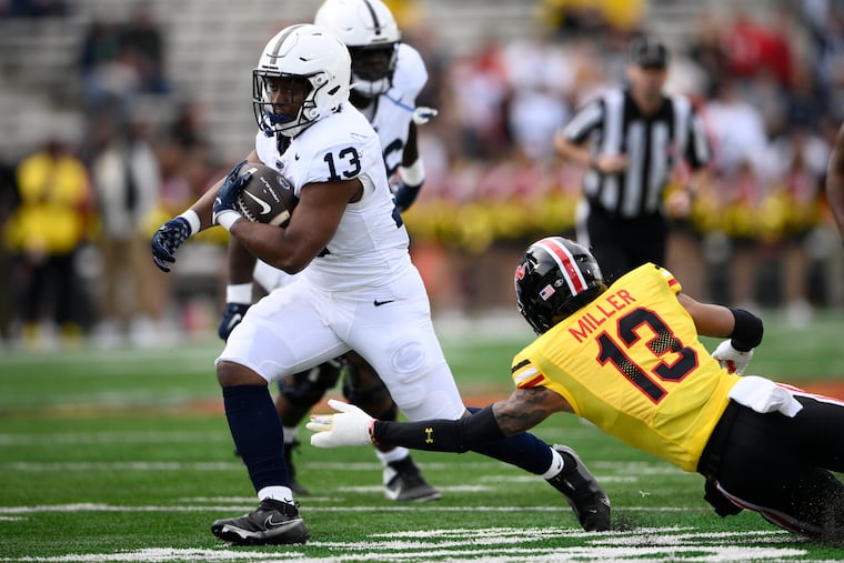 Penn State running back Kaytron Allen (left) runs the ball past Maryland defensive back Glendon Miller during the first half.