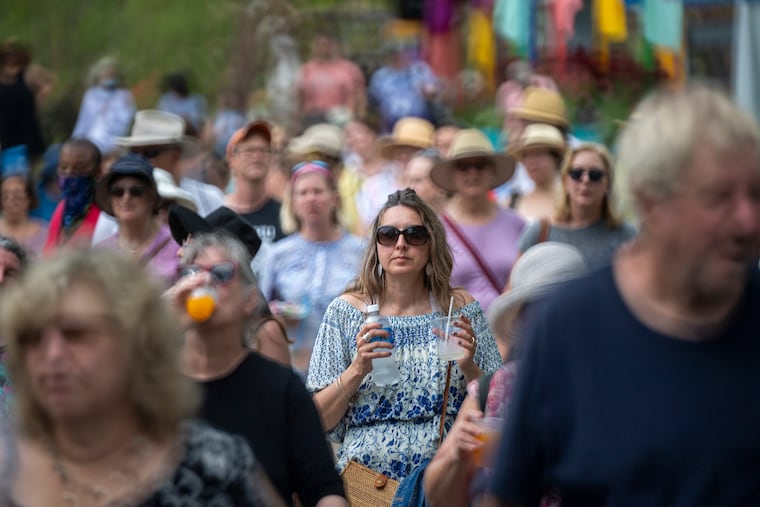 Visitors exit the 2021 Philadelphia Flower Show after a storm warning.