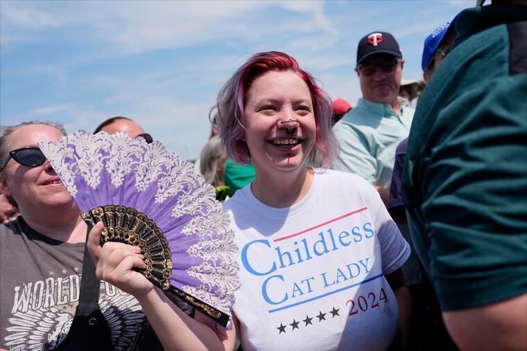 A supporter waits for Democratic presidential nominee Vice President Kamala Harris at a campaign rally in Eau Claire, Wis. Her T-shirt references comments made by GOP vice presidential nominee JD Vance.