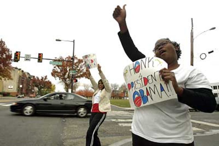 Anna Lawrence, left, and Cheryl Dumas continue celebrating Barack Obama's presidential victory on Broad and Master street this afternoon during a break from their jobs at the YMCA. (Michael Perez / Staff Photographer)