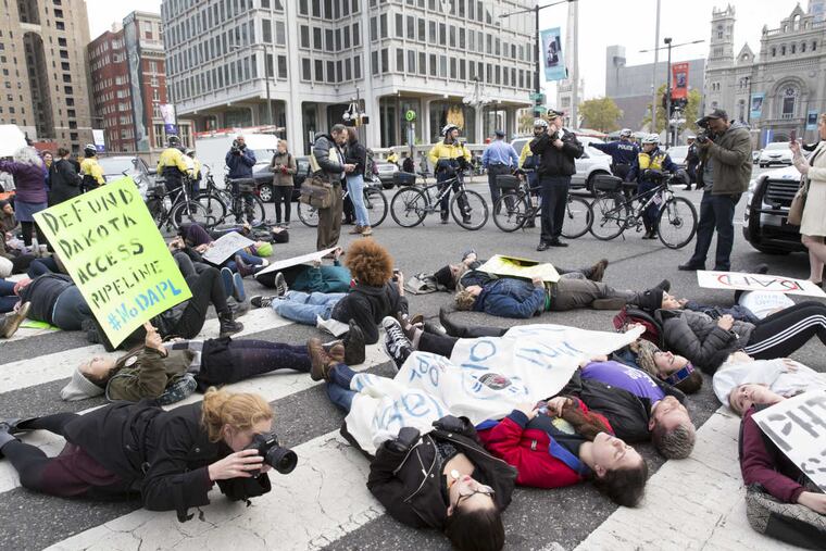 Demonstrators block traffic at 15th Street and JFK Boulevard as part of Tuesday's national day of protest against the Dakota Access Pipeline.