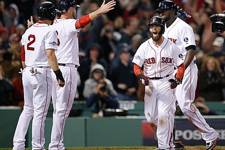 The Red Sox's Jacoby Ellsbury, Will Middlebrooks, Dustin Pedroia and David Ortiz celebrate at the home plate after Ortiz hits a grand slam home run in the eighth inning. (Elise Amendola/AP)