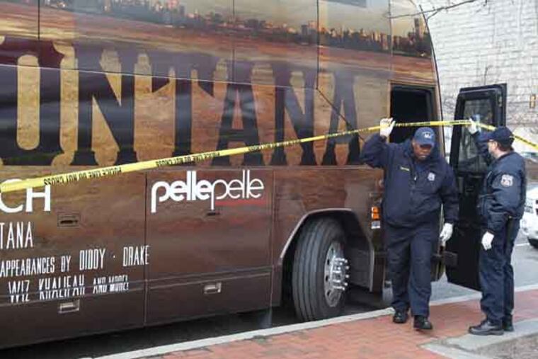 Members of the crime scene unit get off the tour bus of rapper French Montana after searching the bus while it was parked along Delaware Ave. EDITOR'S NOTE: A driver opened fire on a crowd of people surrounding the tour bus of rapper French Montana after a concert in Philadelphia, killing one person and injuring another, according to police. The shooting happened around 11:30 p.m. Thursday (Feb. 28) as the entourage had arrived at a hotel near Penn's Landing after the rapper had headlined a sold-out show at the Theatre of Living Arts. Philadelphia police Chief Inspector Scott Small said a crowd formed around the bus, a car pulled up and someone began shooting. ( CHARLES FOX / Staff Photographer )