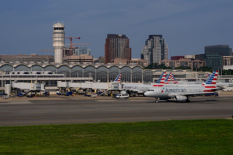 Planes are parked at gates are at Ronald Reagan Washington National Airport in Arlington, Va., Sunday, Aug. 27, 2023, in Washington.