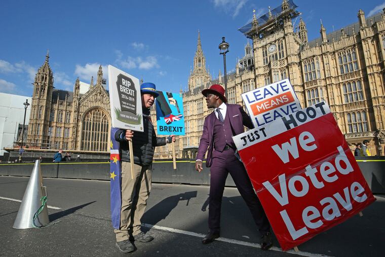 Protestors for opposing views face off against each other, with pro-Brexit split from Europe at right, and pro-Europe anti Brexit at left, outside parliament in London, Monday March 25, 2019. (Jonathan Brady/PA via AP)