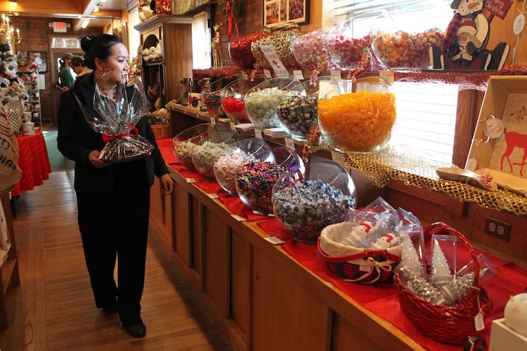 Customer Kim Brady looks over the display at Aunt Charlotte's Candies, a family-owned business that turns 100 in 2020, Merchantville, NJ, December 23, 2019