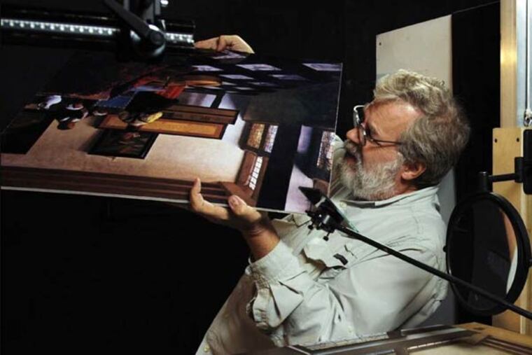 Tim Jenison examines a print of Vermeer's 'The Music Lesson.'