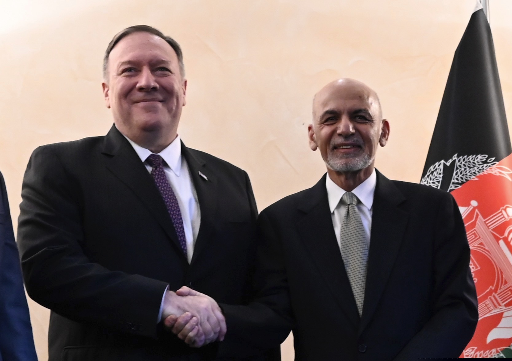 U.S. Secretary of State Mike Pompeo, left, shakes hands with Afghan President Ashraf Ghani,during the 56th Munich Security Conference (MSC) in Munich, southern Germany, on Friday, Feb. 14, 2020.