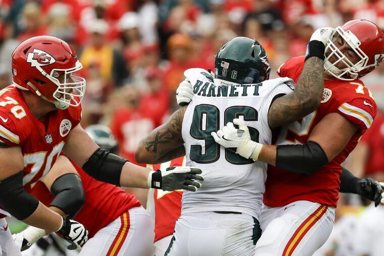 Eagles defensive end Derek Barnett gets double-teamed by Chiefs offensive tackle Eric Fisher (right) and guard Bryan Witzmann.