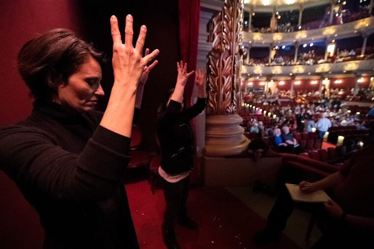 ASL interpreters from Hands UP Productions Charity Johnson (left) and Beth Applebaum, rehearse sign prior to Tuesday's "Mean Girls" show at the Academy of Music