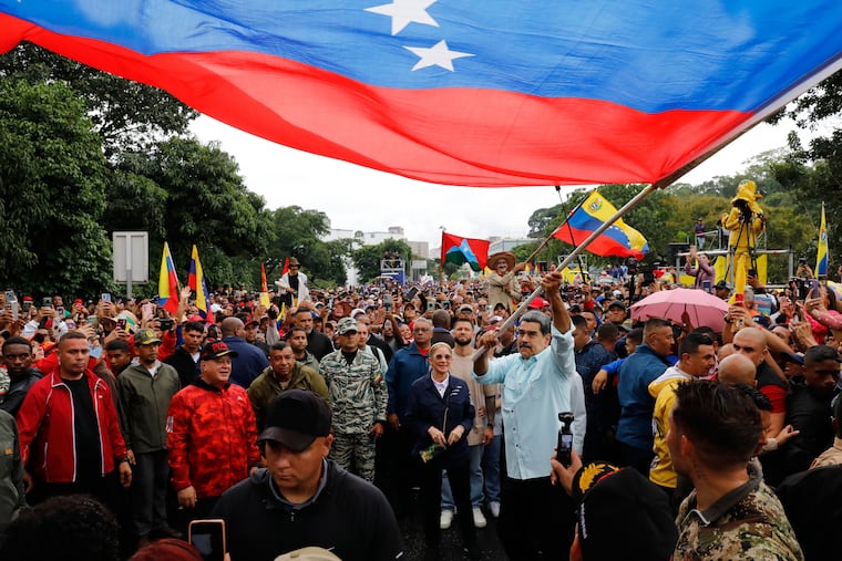 President Nicolás Maduro waves a flag during a Dec. 10 rally marking the anniversary of the Battle of Santa Ines, which took place during Venezuela's 19th-century Federal War, in Caracas, Venezuela.