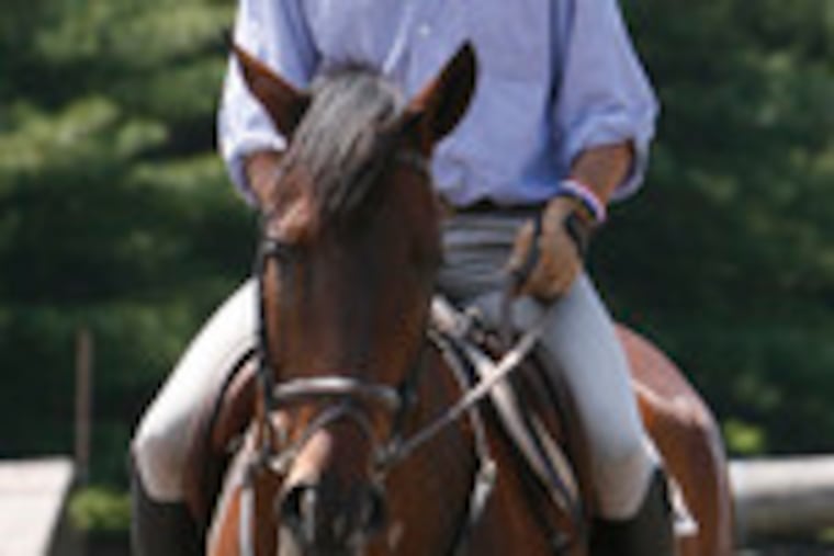 Phillip Dutton practices jumping with Lukipela. Dutton won gold medals for his native Australia in Atlanta (1996) and Athens (2004).
