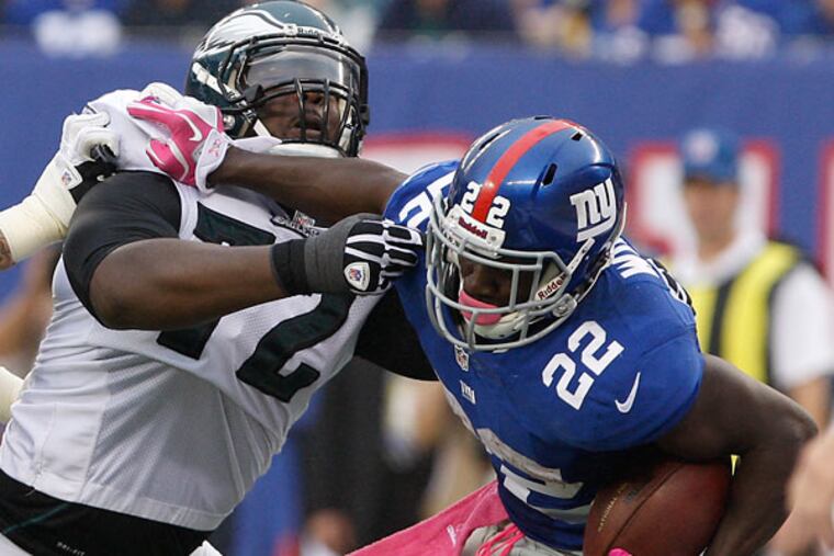 Cedric Thornton tackles the Giants running back David Wilson. (David Maialetti/Staff Photographer)