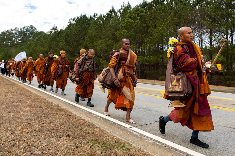 Buddhist monks on a "Walk for Peace" walk on Veterans Parkway in Fayetteville, Ga., on Monday, Dec. 29, 2025, from Texas to Washington, D.C. (Arvin Temkar/Atlanta Journal-Constitution via AP)