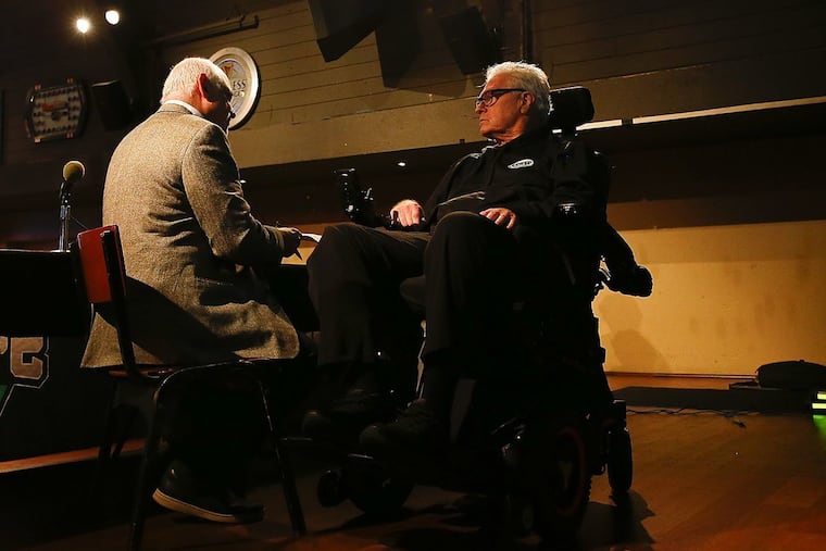 Philly radio host and comedian Big Daddy Graham (right), seen here at a book premier in November with WIP host and co-author Glen Macnow, will return to the comedy stage for the first time since emergency surgery in July left him paralyzed.