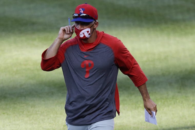 Phillies manager Joe Girardi on the field during a break against the Washington Nationals in an exhibition game at Nationals Park in Washington on Saturday.