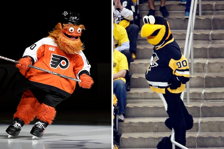 Flyers mascot Gritty (left) has been terrorizing Penguins mascot, Iceburgh, since Day 1.
