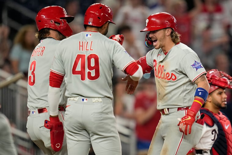 Bryson Stott (right) celebrates his three-run homer against the Nationals as part of an eight-run inning for the Phillies in the ninth.