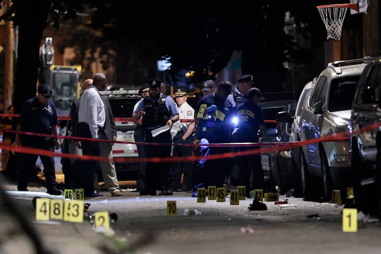 Police investigate the scene in the 1500 block of Etting Street in Philadelphia after thirteen people were shot there just before 1 a.m. Monday. According to Philadelphia Police Commissioner Kevin Bethel, three of the 12 people shot have died.
