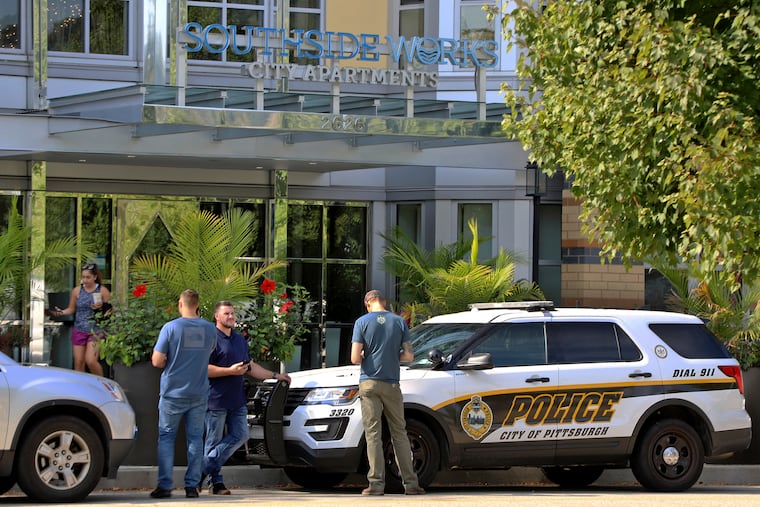 Pittsburgh police investigators gather outside an apartment building on the city's South Side where police say multiple people are dead and others are hospitalized in what they're calling a "medical situation" Sunday, Sept. 22, 2019 in Pittsburgh. (AP Photo/Gene J. Puskar)