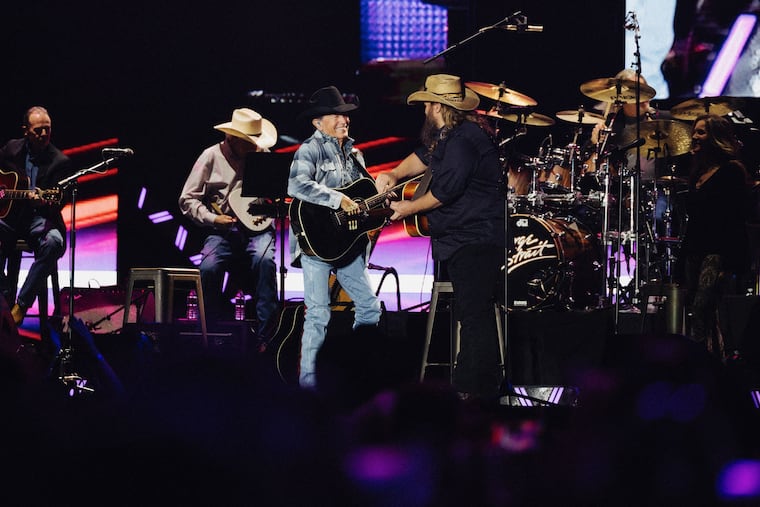 Chris Stapleton joins country legend George Strait on stage at Lincoln Financial Field on Saturday.