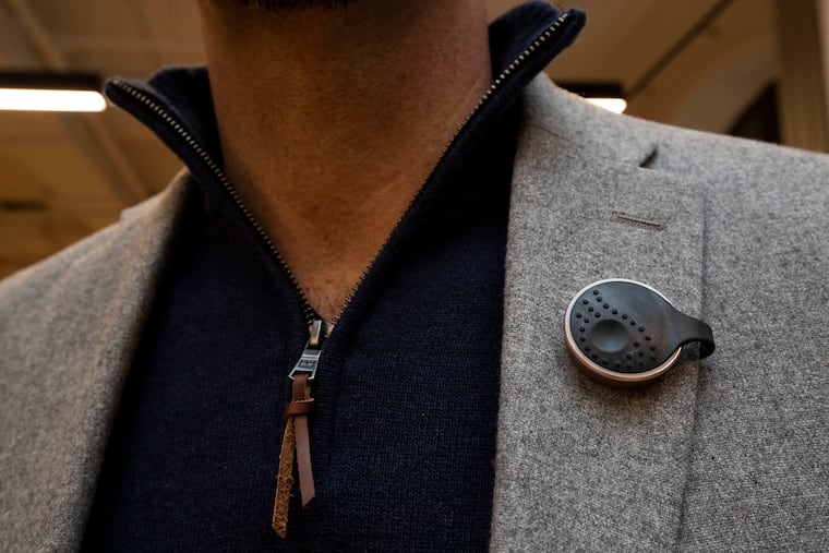 Michael Marks, SVP of business development, wears an "AlwaysOn" safety alert device at SPACES in Philadelphia on Nov. 27. The team worked on "AlwaysOn," a safety device to be used by employees like hotel housekeepers.
