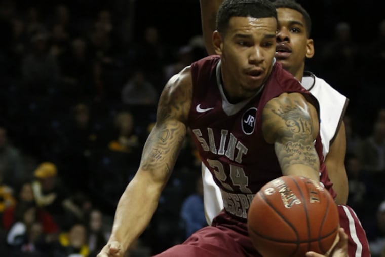 Saint Joseph's Chris Wilson drives past St. Bonaventure's Denzel Gregg
during the second half. (Yong Kim/Staff Photographer)