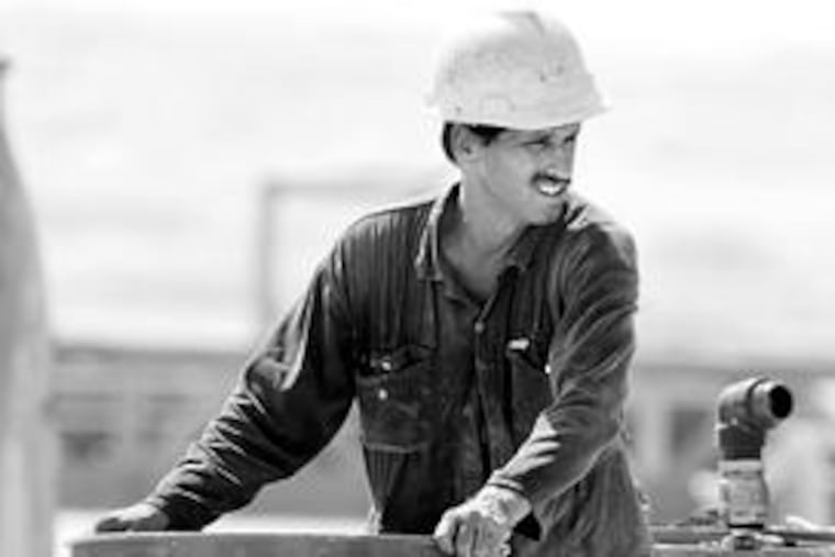 An employee of the Bahrain Petroleum Co. moves an oil drum in the Sakhir, Bahrain, desert oil fields. The oil-producing group OPEC is meeting tomorrow in Algeria to agree on strategies to counteract recent cuts in oil prices. One possible move is that Russia may join the oil cartel in pulling back on production. Story, C4.
