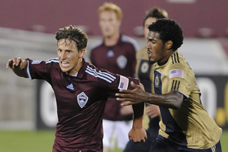 Rapids midfielder Wells Thompson, left, competes for the ball against the Philadelphia Union defender Darrius Barnes on Wednesday. (AP Photo/ Matt McClain)